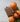 The Simone Cardholder in Brown Clay, beautifully next to oranges in an editorial photo