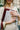 Woman holding her Lenni Laptop Sleeve in Sweet Cherry by Esnner, with keys and magazines, in a hurry, but keeping everything organised.