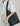 The Mila Hobo bag in Midnight Black, worn on the shoulder in a simple elegant way.